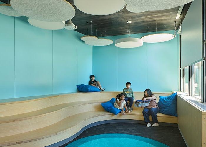 a multi level seating area with blue walls